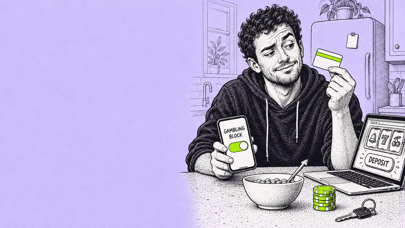 A man at his kitchen counter holds up a debit card and a phone showing a Gambling Block toggle, a laptop with a slot lobby and a Deposit button beside a bowl of cereal and a stack of casino chips.